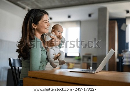 Mother with baby having video call online, conversation with relatives, communicating with friends