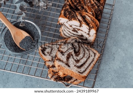 Close up slice traditional Romanian sweet bread cozonac on a hot stand on a concrete table. Eastern European Food Holiday. Festive traditional Romanian dessert. top view. High quality photo Royalty-Free Stock Photo #2439189967