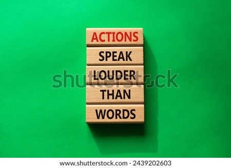 Actions speak louder than Words symbol. Wooden blocks with words Actions speak louder than Words. Beautiful green background. Business and Actions concept. Copy space.