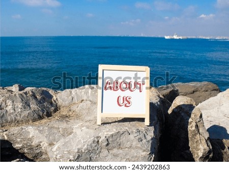 About us symbol. Concept word About us on white chalk background. Beautiful sea background. Business and About us concept. Copy space
