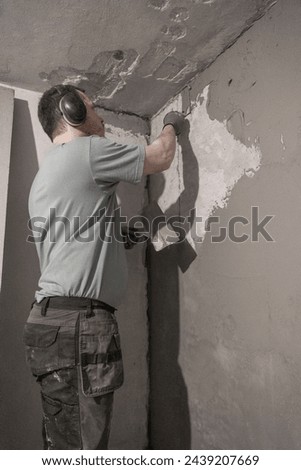 Detailed Close-Up of Man Expertly Plastering Wall, Creating Smooth and Even Surface.