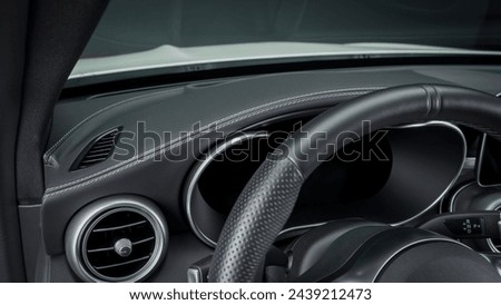 Steering wheel inside of a car Royalty-Free Stock Photo #2439212473