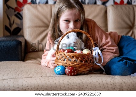 Girl with a bunny and a basket of Easter eggs, sstkEaster