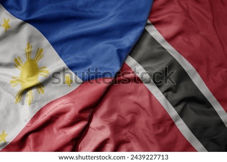 big waving national colorful flag of trinidad and tobago and national flag of philippines. macro