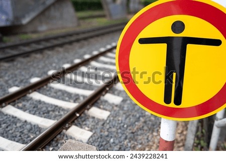 Danger sign for people on the railway track