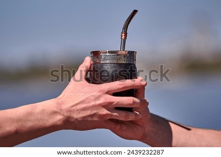 Argentinian breakfast outdoors with mate and bills Royalty-Free Stock Photo #2439232287