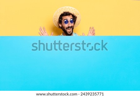 young crazy bearded man expressing a emotion with a copy space