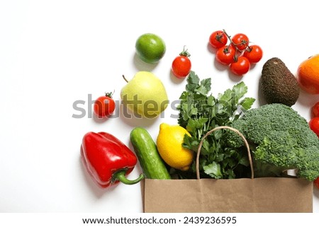 Paper bag, vegetables and fruits on white background, space for text