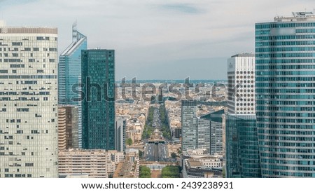 Aerial view of Paris and modern towers timelapse from the top of the skyscrapers in Paris business district La Defense. Traffic on avenue to triumphal arch. Sunny summer day. Paris, France Royalty-Free Stock Photo #2439238931