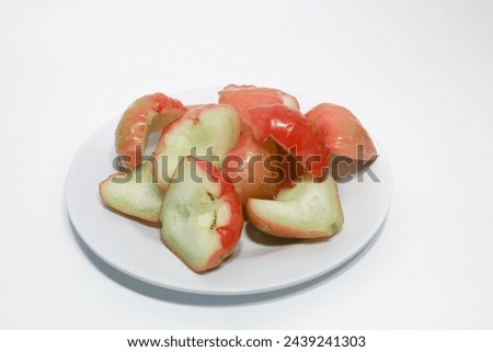 Rose apple isolated, Syzygium aqueum (watery rose apple, water apple, bell fruit, jambu air) fruits on the tree. The fruit has a very mild and slightly sweet taste similar to apples, and a crisp water Royalty-Free Stock Photo #2439241303