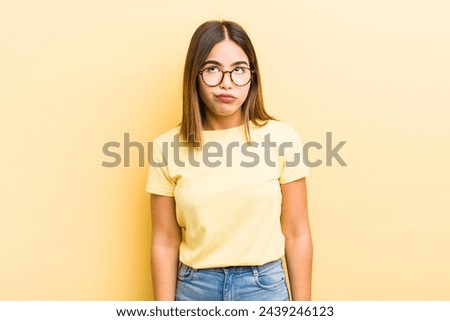 pretty hispanic woman looking goofy and funny with a silly cross-eyed expression, joking and fooling around