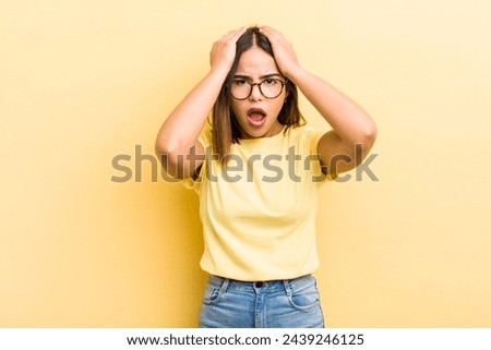 pretty hispanic woman feeling stressed and anxious, depressed and frustrated with a headache, raising both hands to head