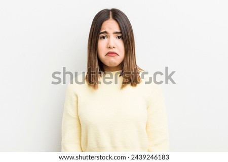 pretty hispanic woman feeling sad and whiney with an unhappy look, crying with a negative and frustrated attitude