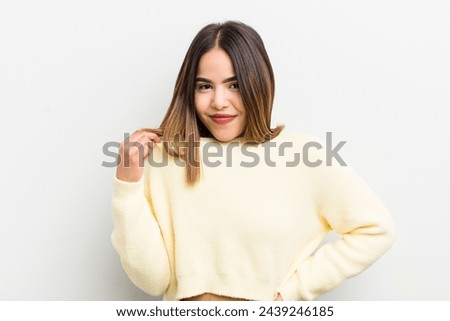 pretty hispanic woman looking arrogant, successful, positive and proud, pointing to self