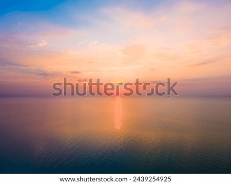 Aerial view of a soothing, colorful sunrise over the Caribbean Sea, filled with orange, pink and blue pastels during a quiet morning on Long Bay Beach, Turks and Caicos Islands Royalty-Free Stock Photo #2439254925