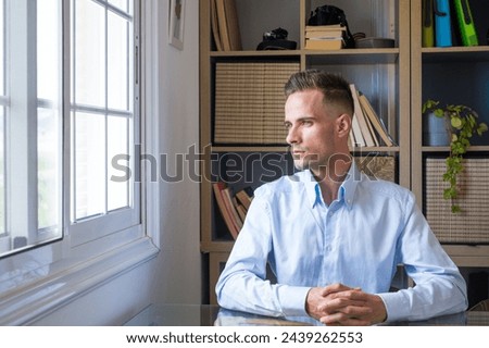 Caucasian reflexive looking at laptop screen, reflexing on work, businessman independent working in a difficult project. Male person preparing at home in the office indoor. Royalty-Free Stock Photo #2439262553