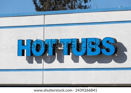 Hot tubs big blue signage on the fasade of shop which sells jacuzzis, fire pits, patio heaters etc.