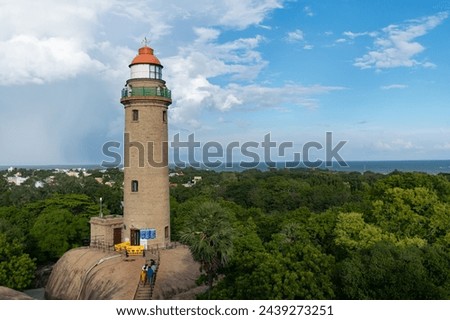 Picture of a lighthouse tower with blue sky in the background at UNESCO world heritage site of Mahabalipuram. Ajanta, Ellora, Hampi ancient stone sculpture carvings sacred pilgrimage archeology stone