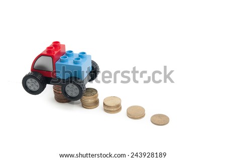 Toy car and stack of gold coins isolated on white background