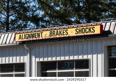 Alignment Brakes Shocks yellow signage on a tire shop auto car repair center