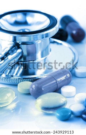 Stethoscope and Colorful of oral medications on White Background.