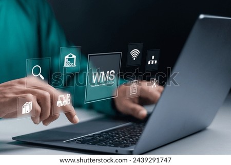 WMS, Warehouse Management System concept. Develop warehouse system management and increase efficiency of work in warehouses. Businessman using laptop with WMS icons on virtual screen. Royalty-Free Stock Photo #2439291747
