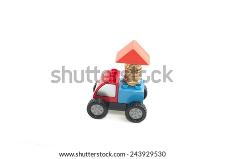 Toy car and stack of gold coins isolated on white background.