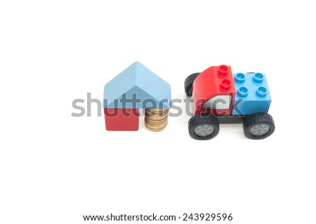 Toy car and stack of gold coins isolated on white background.