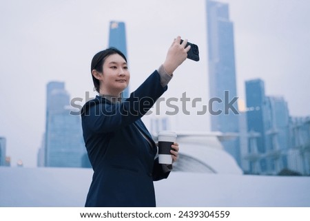 Businesswoman Taking Selfie with City Skyline