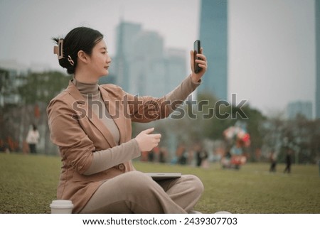 Young Woman Taking Selfie in City Park