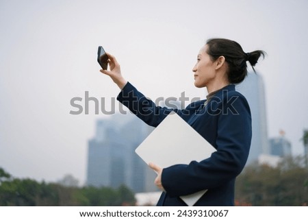 Professional Woman Taking Selfie with Smartphone Outdoors