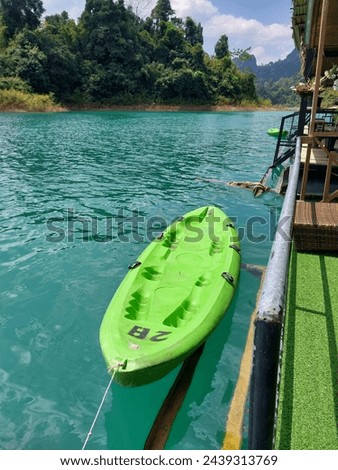 Green kayak for adventure traveler on blue lagoons water at  Ratchaprapha Dam Chiao Lan Dam suratthani

 Royalty-Free Stock Photo #2439313769