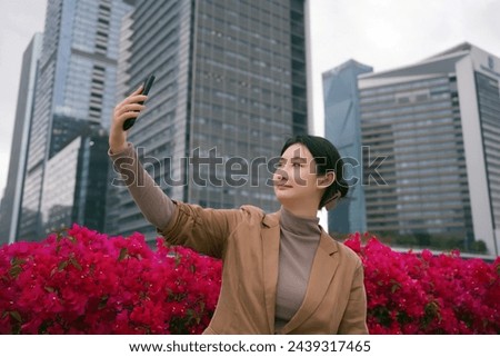 Businesswoman Taking Selfie Amidst Cityscape