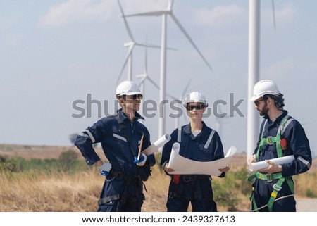 engineers working in fieldwork outdoor. Workers walking and inspect construction and machine around project site. Wind turbine electrical of clean resource enerdy and environment sustainable.