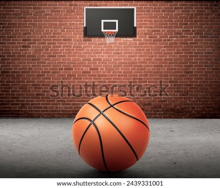 Basketball ball and basketball hoop on brick wall and cement floor