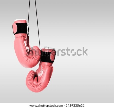 Breast cancer awareness. Pair of pink boxing gloves on light grey background, space for text Royalty-Free Stock Photo #2439335631