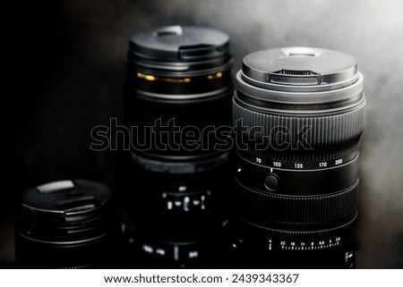 close up of a camera lens on a black background with shallow depth of field
