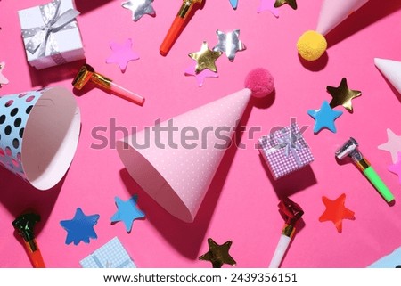 Flat lay composition with party hats on pink background
