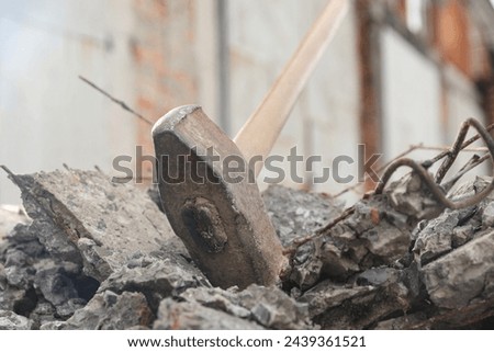 Sledgehammer on pile of broken stones outdoors, closeup Royalty-Free Stock Photo #2439361521