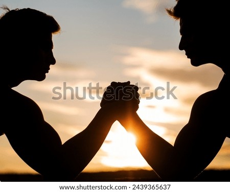 Silhouette of hands that compete in strength. Rivalry, closeup of male arm wrestling. Men measuring forces, arms. Two men arm wrestling. Rivalry, vs, challenge, strength comparison. Sunset, sunrise.