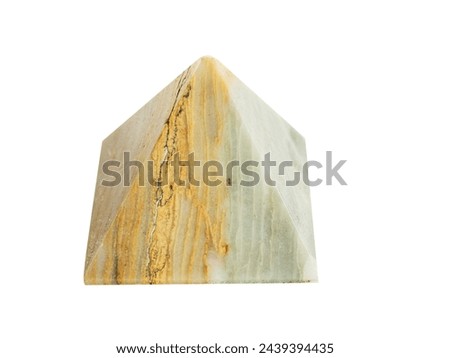 Polished marble pyramid on white background for home decoration or spiritual practice and meditation. Brown and light yellow color of rock texture. Selective focus.