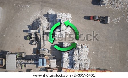 Recycle factory with garbage cubes waiting for sorting with graphic sign of recycling