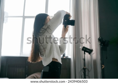 Female Photographer Capturing a Couples Portrait in a Bright Studio Setting