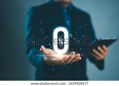 Businessman holding glowing zero percentage or 0 percent for special offer of shopping department store and discount concept. Interest rate, installment payment, promotion, marketing, boost sales Royalty-Free Stock Photo #2439409677