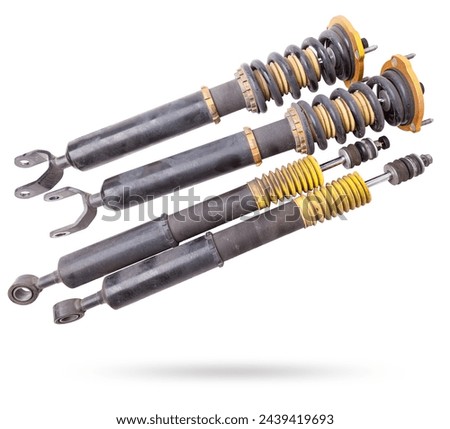 Shock absorber struts with black springs after being used on a car during replacement and repair on a white isolated background. Used spare parts. Auto parts catalog. Royalty-Free Stock Photo #2439419693