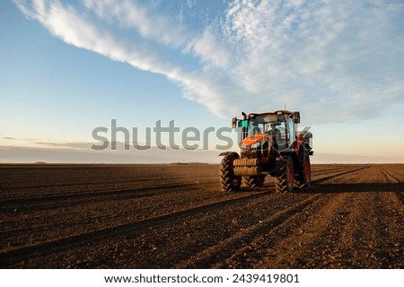 Tractor spreading artificial fertilizers. Transport, agricultural. Royalty-Free Stock Photo #2439419801