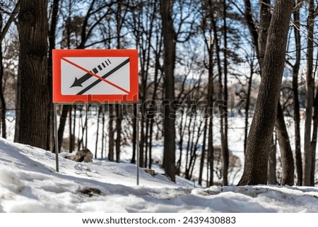 a sign prohibiting descent from the slope stands on a hill in the forest. prohibition of descent from the slope Royalty-Free Stock Photo #2439430883