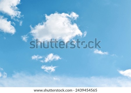 Blue sky with white fluffy cloud. Cumulus clouds background. Beautiful sky in the morning. Cloudscape backdrop. Summer spring autumn winter sky. Freedom of life concept.  Royalty-Free Stock Photo #2439454565