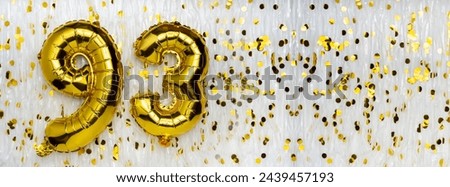 Gold foil balloon number, digit ninety-three. Birthday greeting card with inscription 93. Anniversary celebration. Banner. Golden numeral, white background. Numerical digit. Copy space Royalty-Free Stock Photo #2439457193