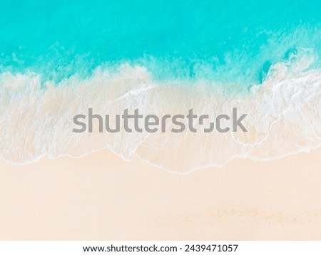 waves from the turquoise water of Grace Bay Beach, Providenciales gently break on the  empty white sand beach, seen from a top down aerial view with no people in photo Royalty-Free Stock Photo #2439471057